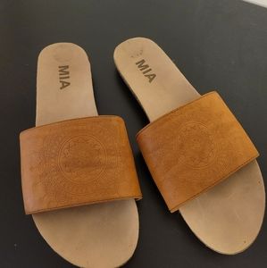Brown faux leather slides with embossing